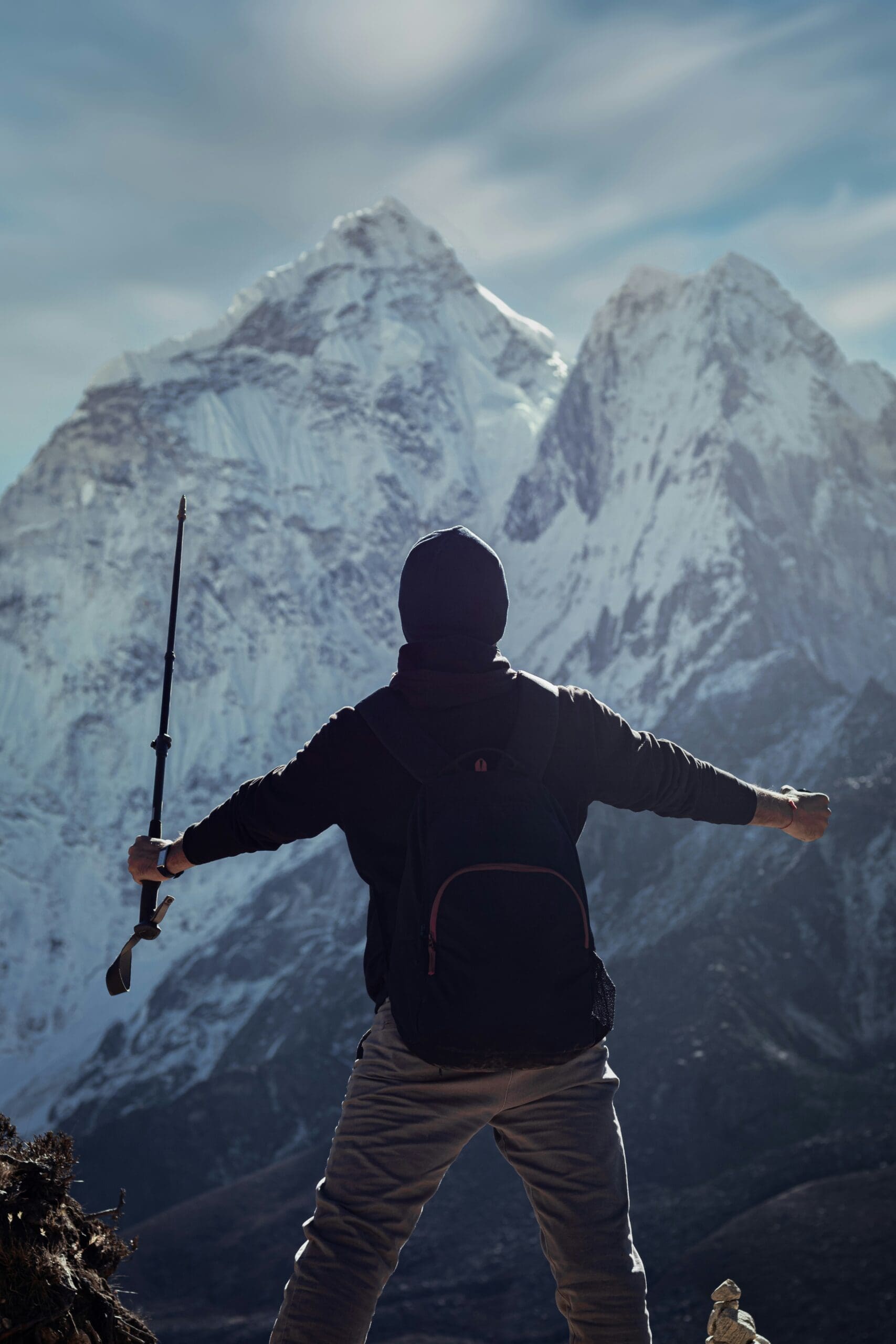 A rugged, rocky mountain peak viewed from above, under clear skies—a metaphor for confidence earned through challenge and exposure.