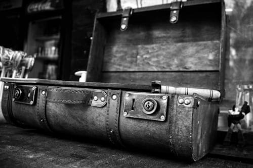Open vintage leather briefcase on display in black and white