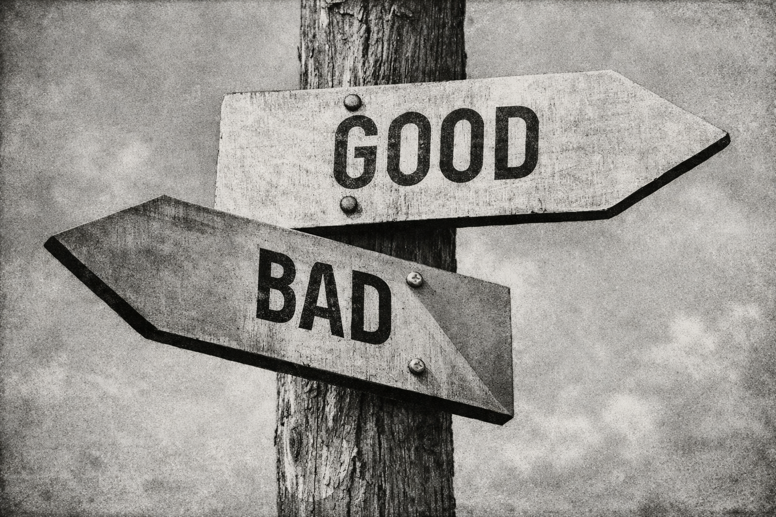 Black-and-white vintage-style image of a wooden post with two directional signs reading “GOOD” and “BAD,” pointing in opposite directions.